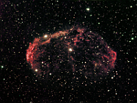 NGC 6888  Crescent Nebula. Taken at home between 07/07/06 and 07/24/06.  Meade RCX400 10" scope, DSI-Pro camera. A 2x2 mosaic.  30 to 60 seconds/frame, total time 10.3 hours. A Hydrogen-Alpha filter was used for the red component of the image, an Ultra High Contrast filter was used for the green component, and a blue filter + ALP filter gave the blue component.